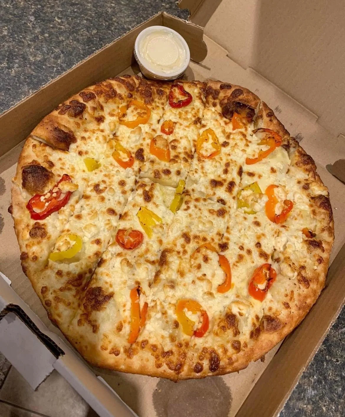 Garlic fingers with hot peppers and a cup of donair sauce